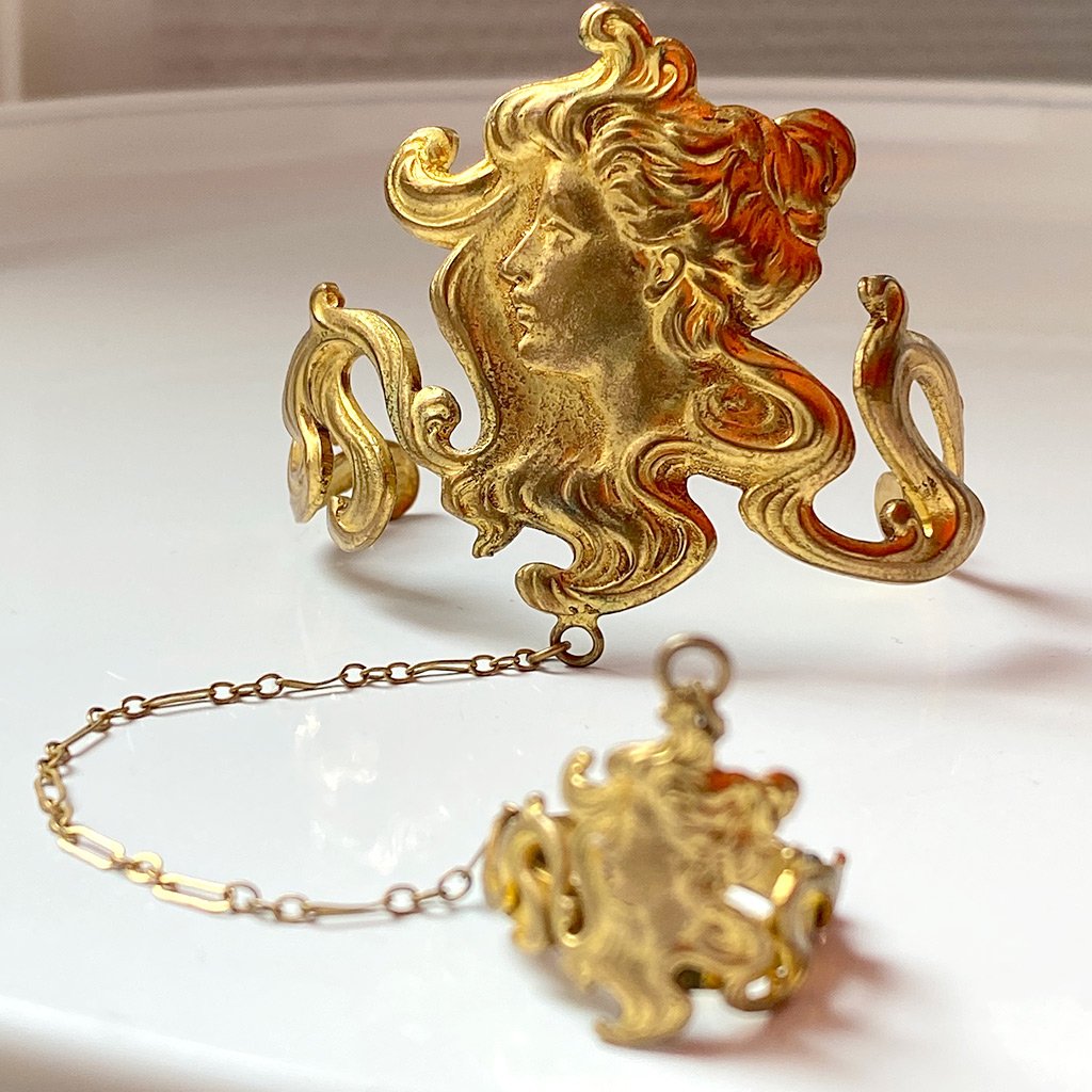 photo of elaborate gold cameo bracelet with gold chain connecting it to matching gold cameo ring, also elaborate