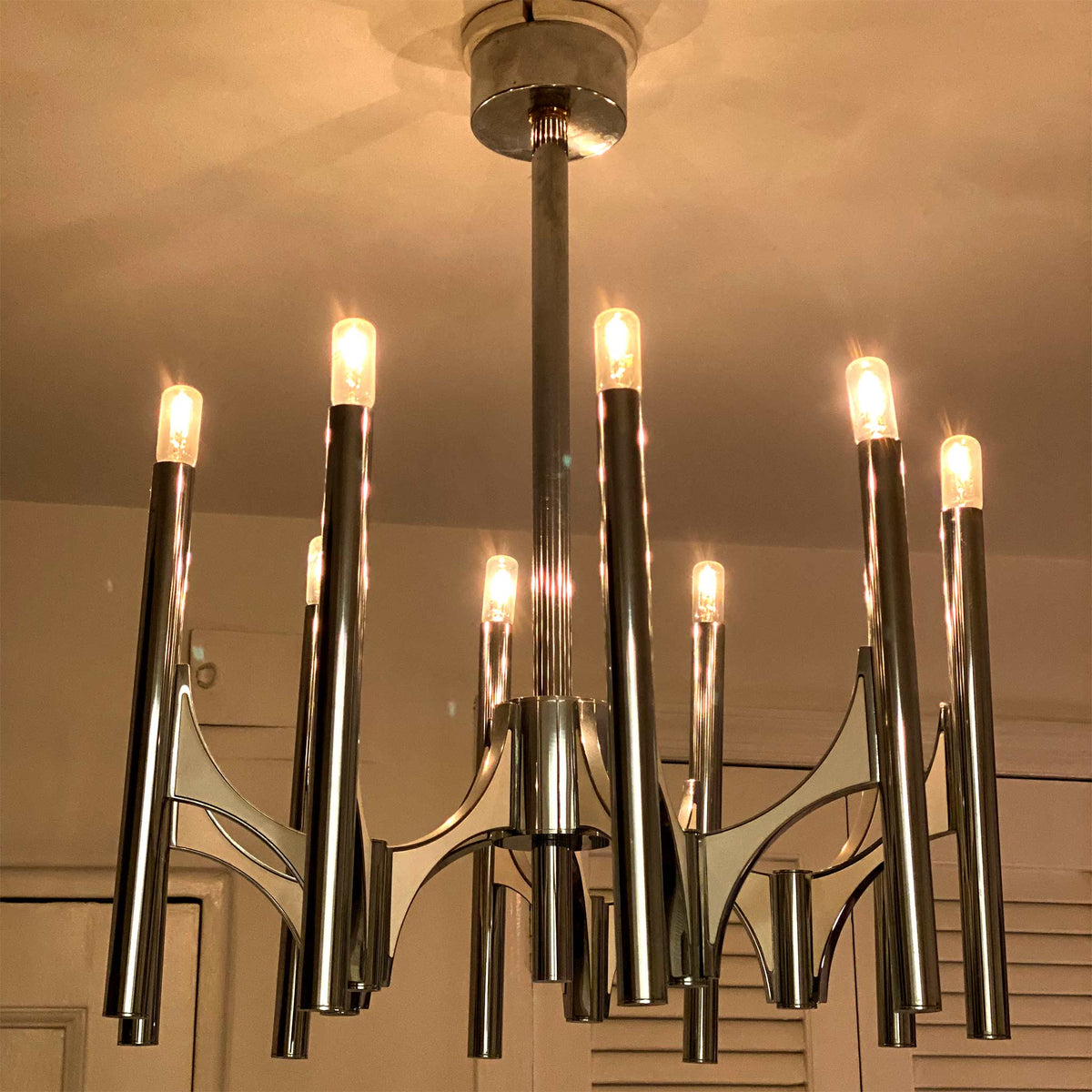 photo of 10-lamp chrome chandelier with lamps shining brightly from mindscapade