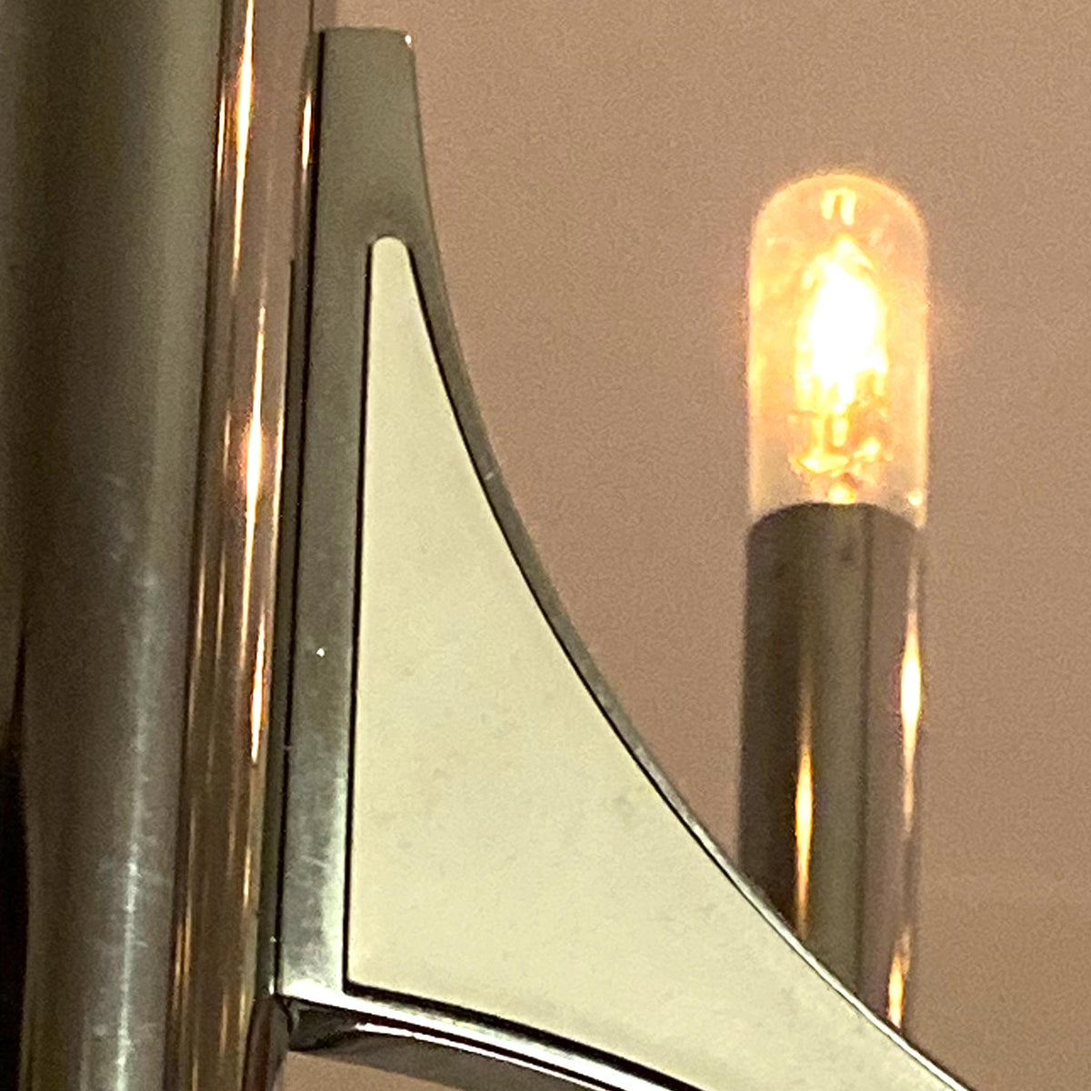 photo of 10-lamp chrome chandelier close up of one lamp and one of five flying buttress-like arm from mindscapade