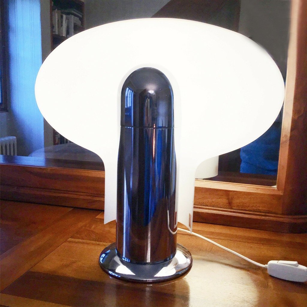 photo of unique stilnovo leuke lamp showing opal acrylic shade glowing behind heavy chrome fixture base from mindscapade